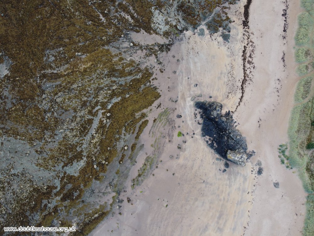 bearch seen from above, sand and rocks