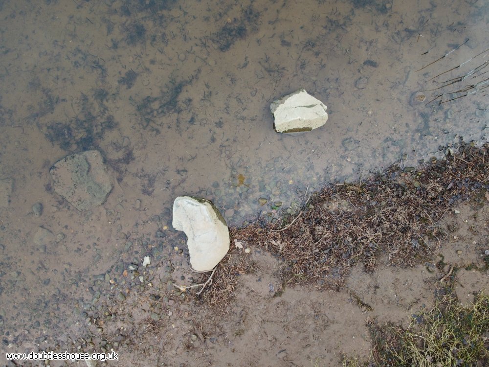 2 rocks on shore line from above